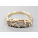 An early 20th century 18ct and graduated five stone diamond set half hoop ring, size P/Q, gross