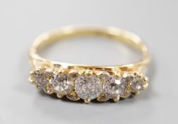 An early 20th century 18ct and graduated five stone diamond set half hoop ring, size P/Q, gross