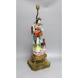 An early 20th century Chinese brass mounted porcelain figural lamp, total height 59cm