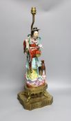 An early 20th century Chinese brass mounted porcelain figural lamp, total height 59cm
