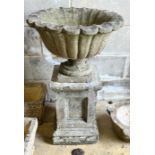 A reconstituted stone campana garden urn on square plinth, diameter 49cm, height 82cm
