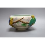 A late Clarice Cliff bowl with perched parrot decoration, 12cm tall