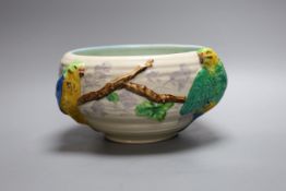 A late Clarice Cliff bowl with perched parrot decoration, 12cm tall