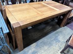 A large contemporary rectangular oak dining table, with removable end leaves, length 280cm extended,