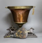 A Victorian copper vase on plinth base, a pair of Victorian cast iron recumbent dog door stops and a