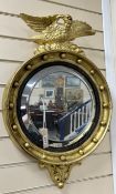 A 19th century Regency style circular wall mirror with eagle surmount, width 46cm, height 70cm