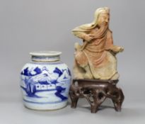 A Chinese soapstone carving of a deity and a similar early 19th century blue and white jar,