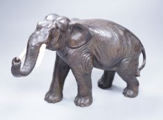 A Japanese Meiji period cast bronze model of an elephant, with ivory tusks, 17cm tall Ivory