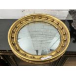 A Regency mahogany circular gilt framed convex wall mirror, diameter 49cm