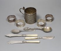 A 19th century Indian white metal christening can with cobra handle, a set of four silver napkin