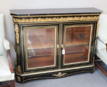 A 19th century French gilt metal mounted ebonised two door side cabinet, width 140cm, depth 38cm,