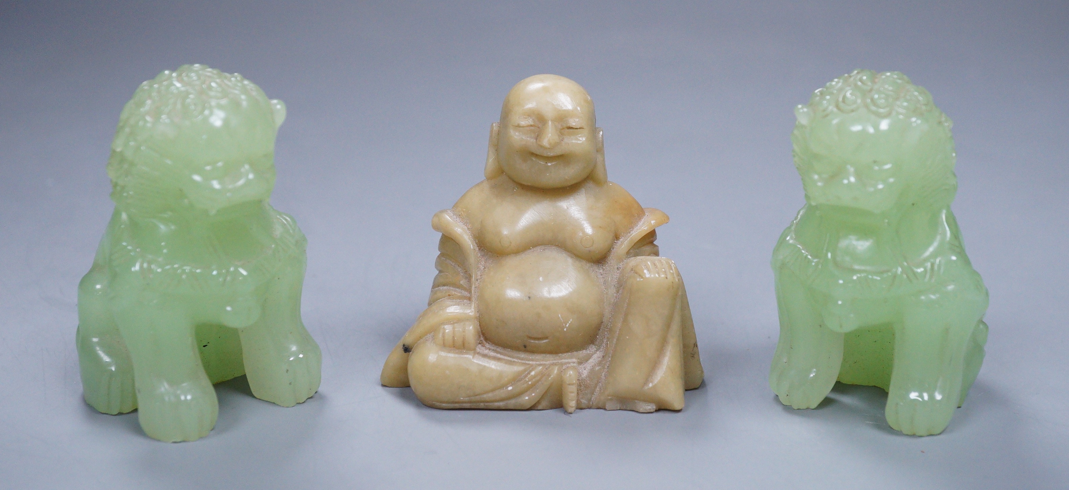 Two bowenite Buddhistic lions and a soapstone Buddha, 7cm