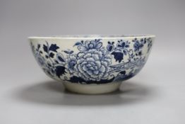 A Liverpool punch bowl, hand painted with flowers and a fence in blue underglaze, 23cm diameter