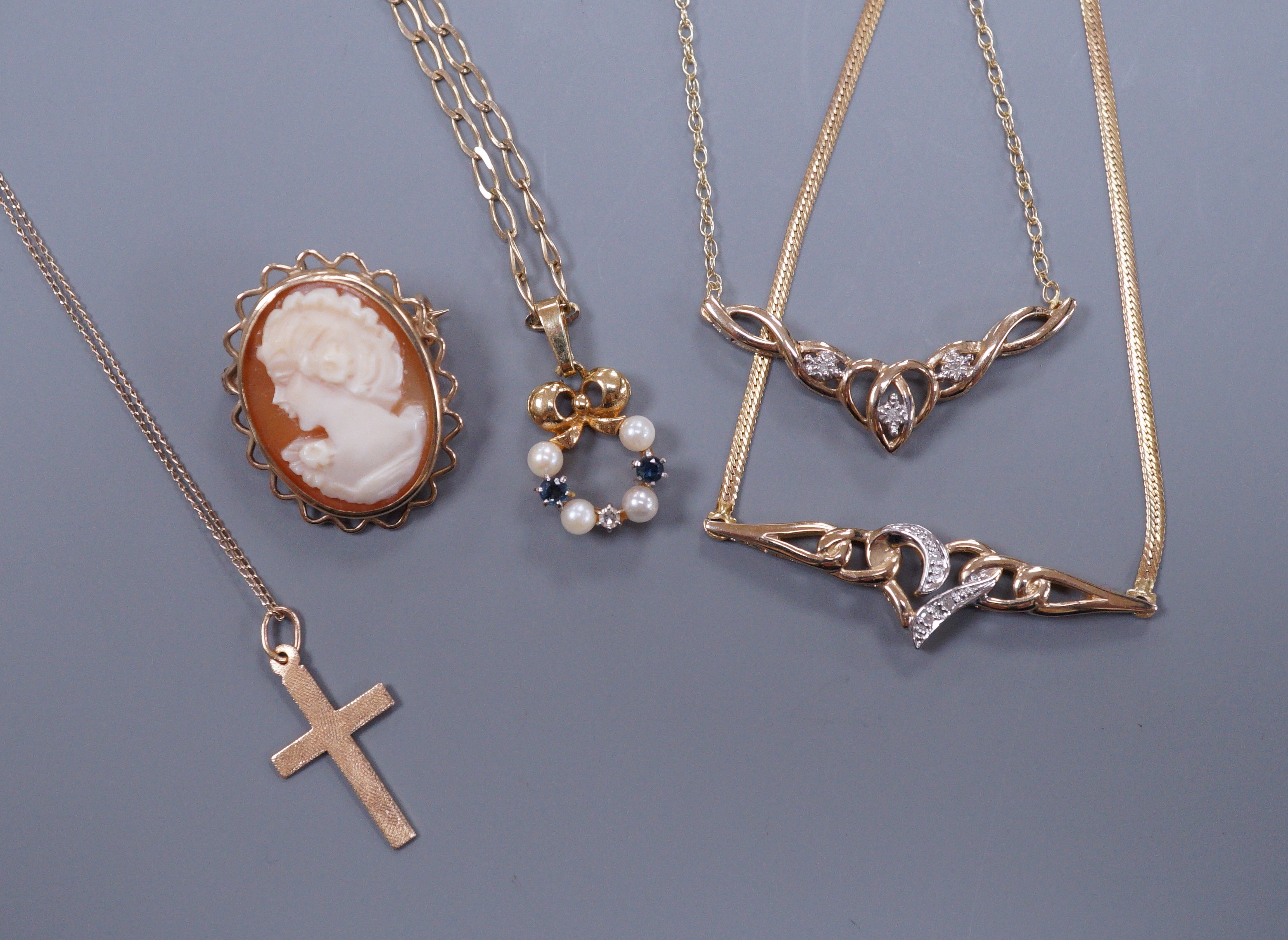 A 9ct gold diamond chip set necklace and matching bracelet, a cross pendant, a sapphire diamond