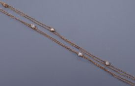 An early 20th century unmarked gold and baroque pearl chain necklace, 137cm
