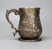 An early George III silver mug, with later-embossed floral detail, London 1762, 12cm., 12oz. -