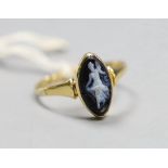 An 18ct gold and black cameo dress ring, carved with a dancing lady, size T, gross 2.8 grams