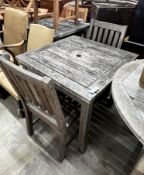 A square weathered teak garden table, width 80cm, height 73cm together with two teak garden chairs