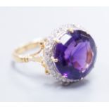 An 18ct gold and platinum, amethyst and diamond circular cluster ring, size M, gross 5.7 grams