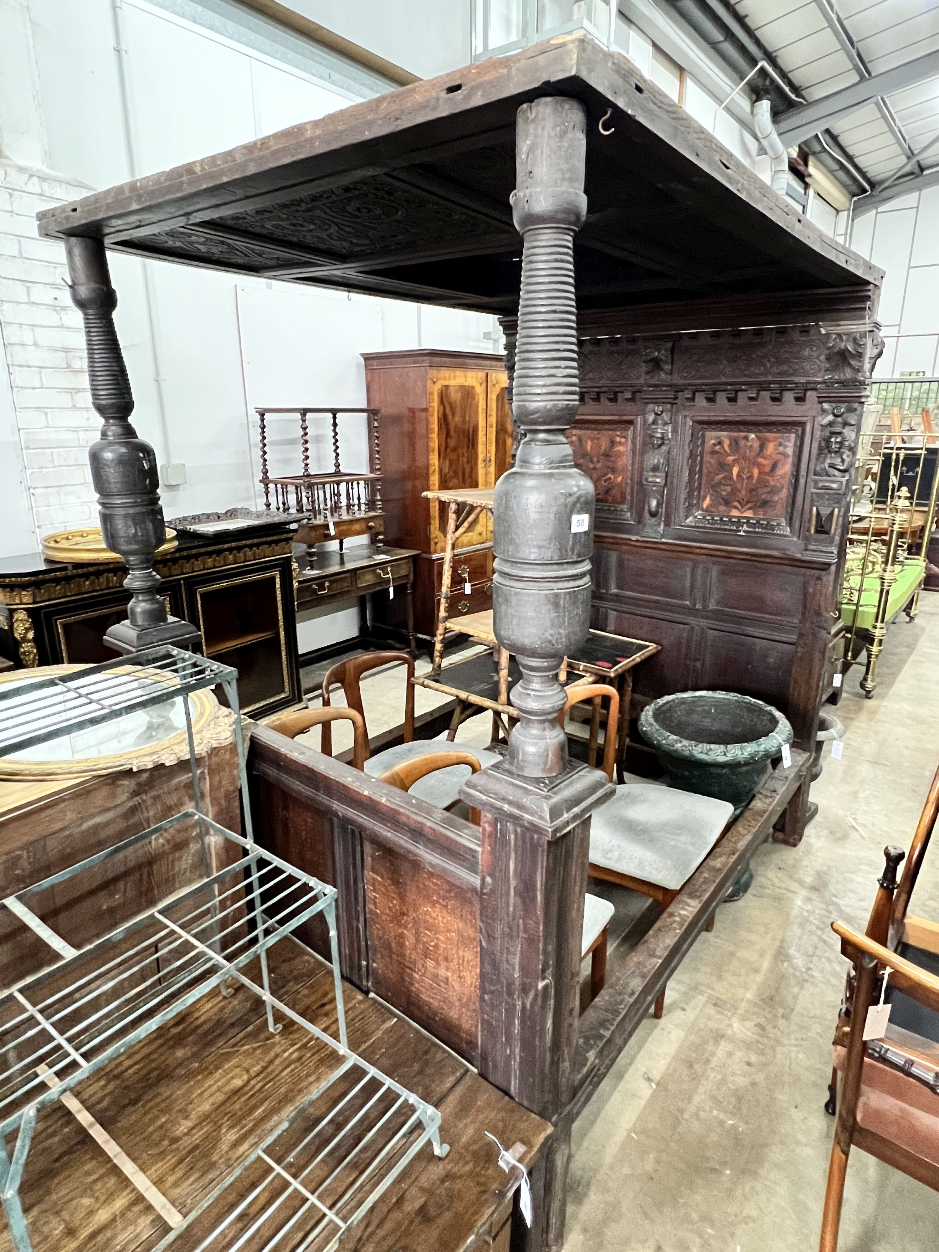 A 17th century style oak tester bedstead, inset with marquetry panels, length 196cm, depth 135cm,