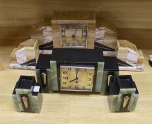 An Art Deco marble and onyx clock garniture, together with another stylised onyx Art Deco marble