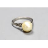 A solitaire cultured pearl set ring, with diamond chip set shoulders, size K