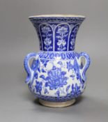 A three-handled blue and white Iznik pottery vase with floral motif, 22.5cm tall