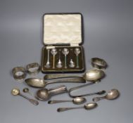 A pair of George III bright cut silver table spoons, three later assorted napkin rings, a cigar