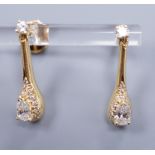 A pair of 18ct gold and diamond drop ear studs, each set with a tear shaped diamond within a