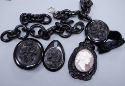 A Victorian floral carved jet brooch with matching bracelet and incomplete chain necklace and a