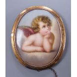 A Victorian gold mounted porcelain brooch decorated with Cupid, 5cm