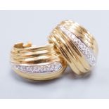 A pair of 18k yellow metal and diamond chip scroll shaped ear-clips, 2cm, gross 13 grams