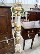 A pair of Italian style painted parcel gilt pricket candlesticks, height 150cm