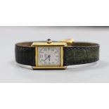 A lady's Must de Cartier silver gilt wristwatch, with quartz movement and blue cabochon winder