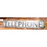 A vintage glass telephone box sign, width 64cm, height 10cm