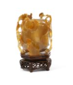 An early 20th century agate 'crab and weed' water pot, wood stand, total height 10cm