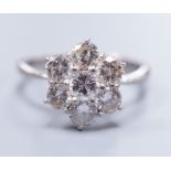 An 18ct white gold seven stone diamond cluster ring, size M, gross 4.1 grams