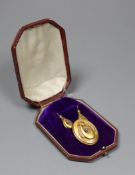 A Victorian 15ct two colour gold and diamond set pendant brooch, of oval form with central
