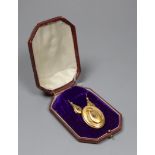 A Victorian 15ct two colour gold and diamond set pendant brooch, of oval form with central