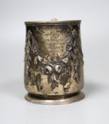 A George III silver pint mug, with later Victorian embossed and chased floral swag decoration and