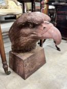 A large weathered cast iron eagle's head garden finial, height 44cm