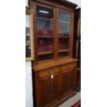 A late Victorian walnut bookcase cupboard, width 121cm, depth 48cm, height 236cm