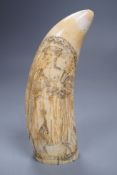 A carved scrimshaw whale tooth titled ‘Ship Dove’, 16cm