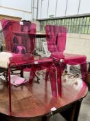 A pair of pink modern design perspex chairs, width 52m, height 84cm