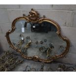 A Victorian carved giltwood shaped oval wall mirror, width 110cm, height 96cm