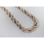A Continental white metal, gilt and oxidised metal three strand ropetwist chain necklace, 50cm