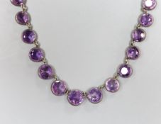 A late Victorian silver mounted circular cut graduated amethyst necklace, 38cm