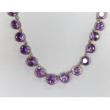 A late Victorian silver mounted circular cut graduated amethyst necklace, 38cm