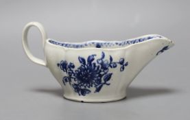 A Liverpool sauceboat decorated in blue underglaze flowers, the interior with further flowers and