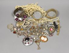Assorted costume jewellery including a silver charm bracelet, hung with various charms including
